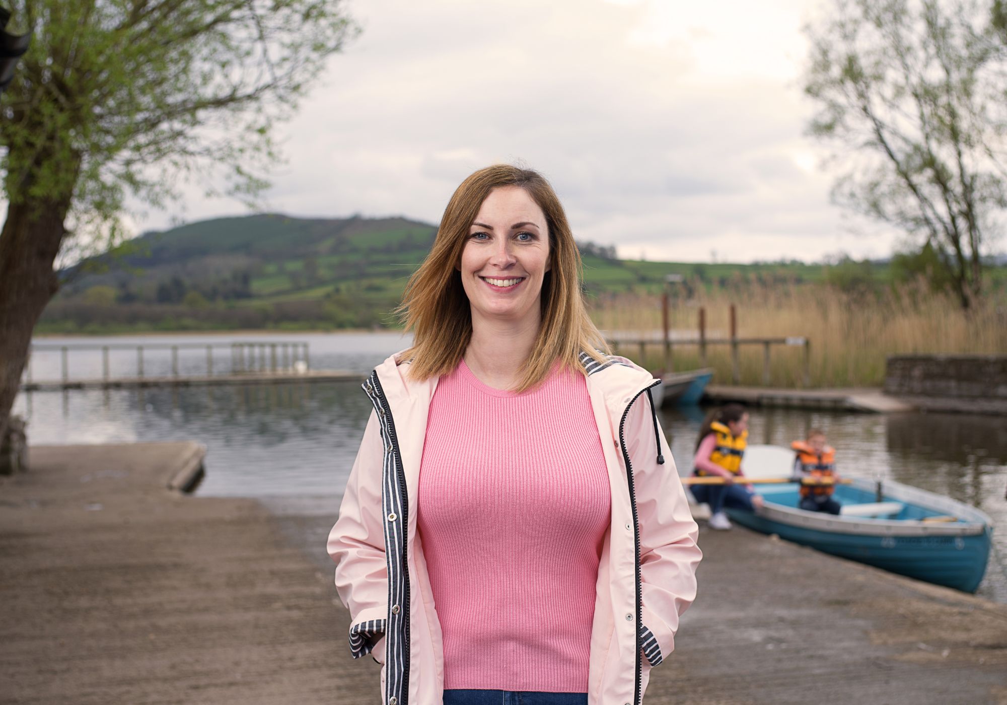 Lady standing next to a lake